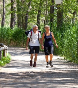 happy couple hiking on an easy path surrounded by trees